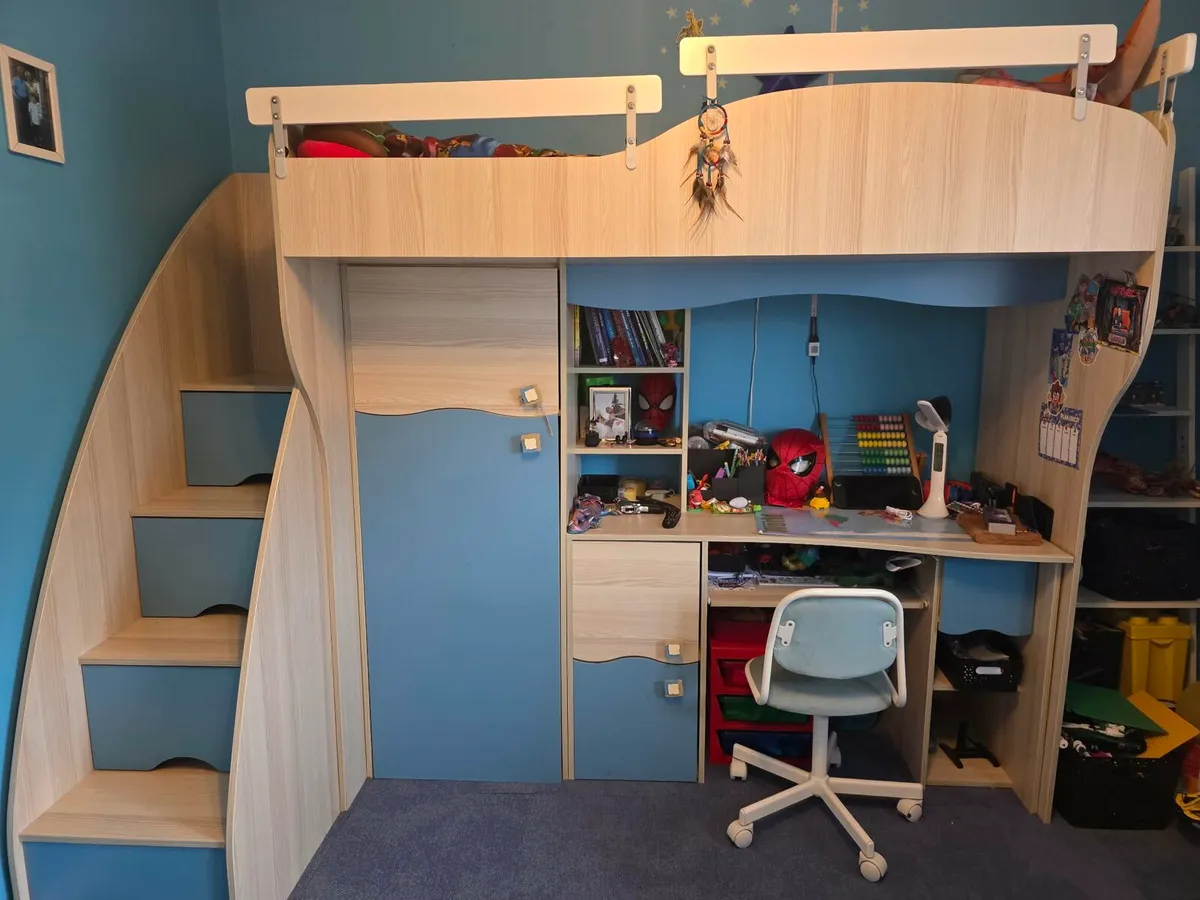 A bunk bed with a desk - Image 1