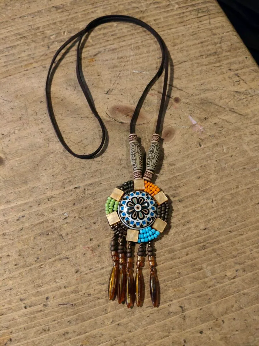 This is a bohemian-style long necklace featuring a - Image 1