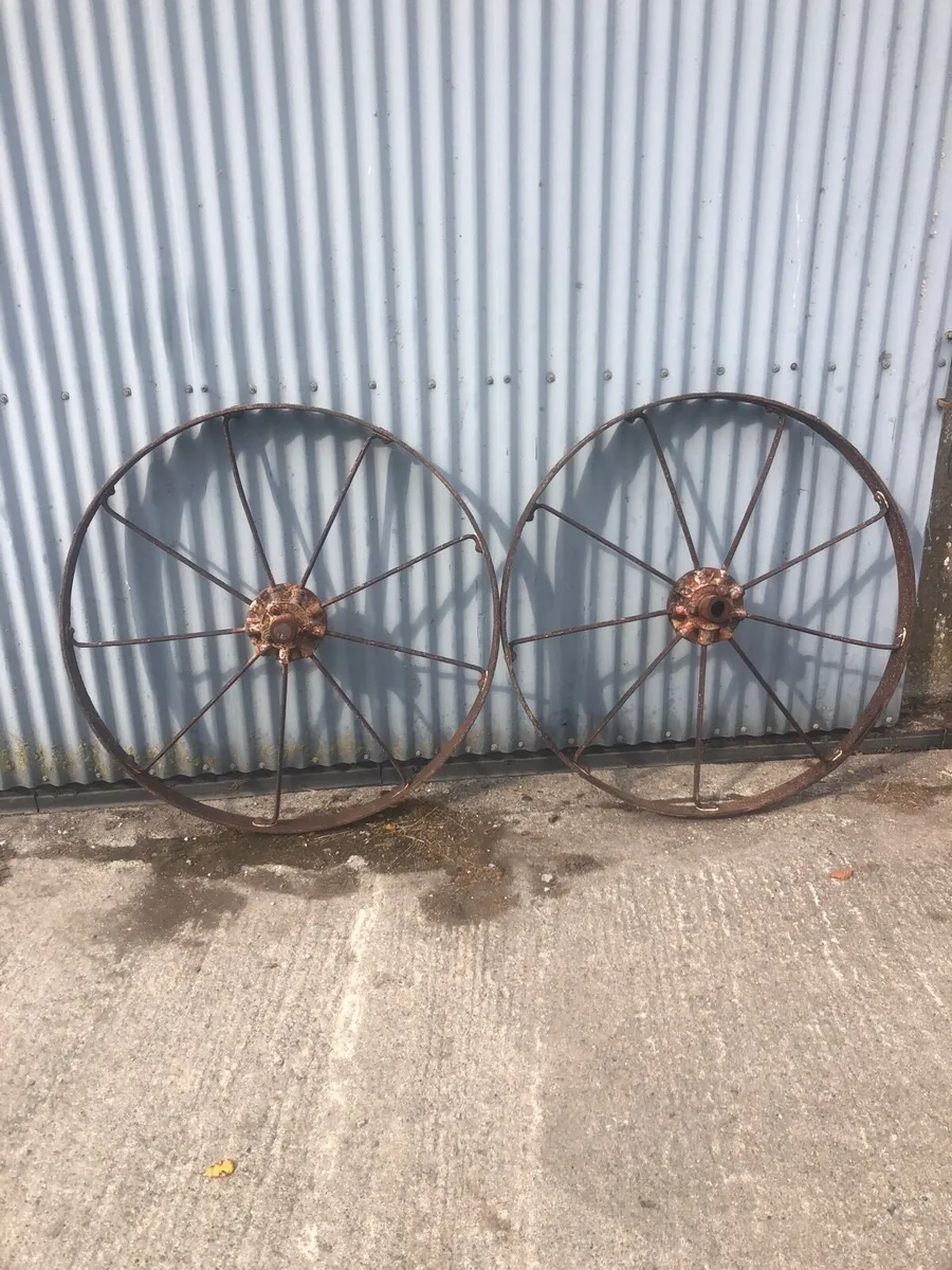 Two cast iron  horse machine wheels