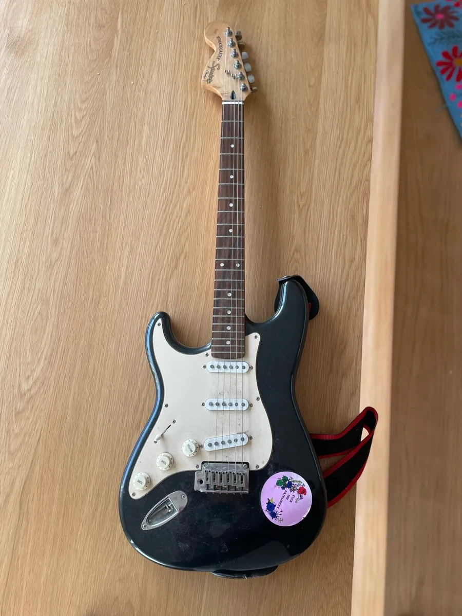 Left-handed Squier Stratocaster guitar by Fender - Image 1
