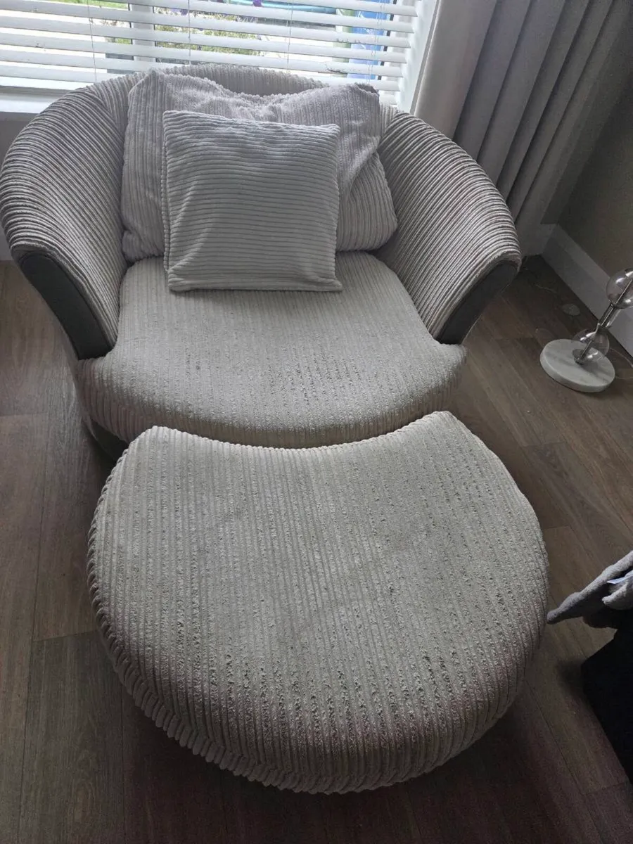 Swivel arm chair with foot rest