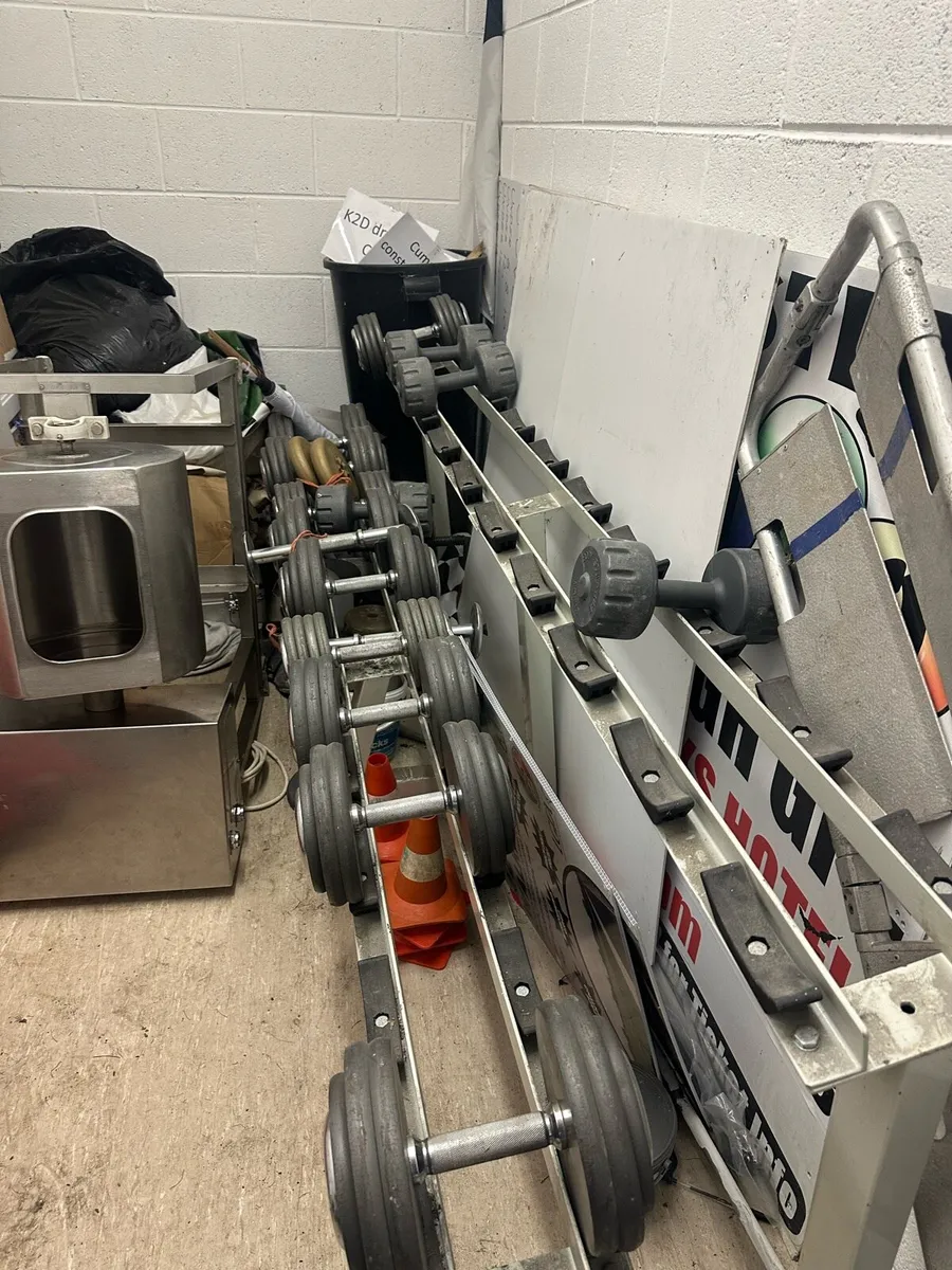 Selection of dumbbells and weight rack for sale. - Image 1