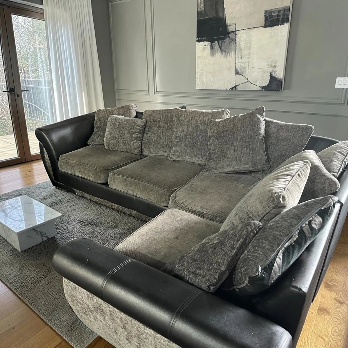 Black and grey corner sofa with matching footstool - Image 1