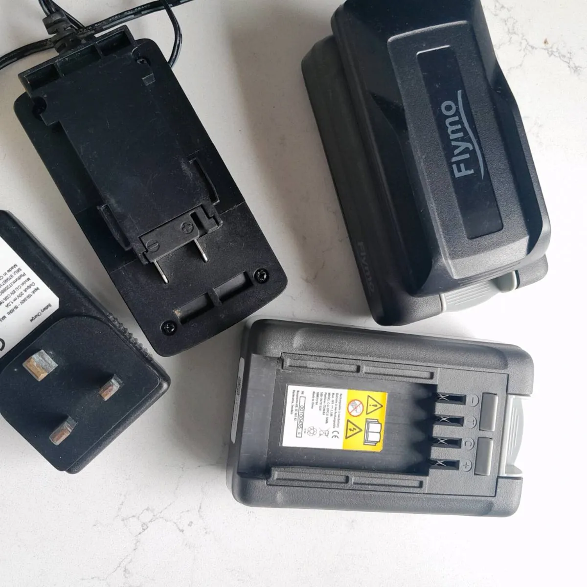 Flymo battery 20v and charger - Image 1