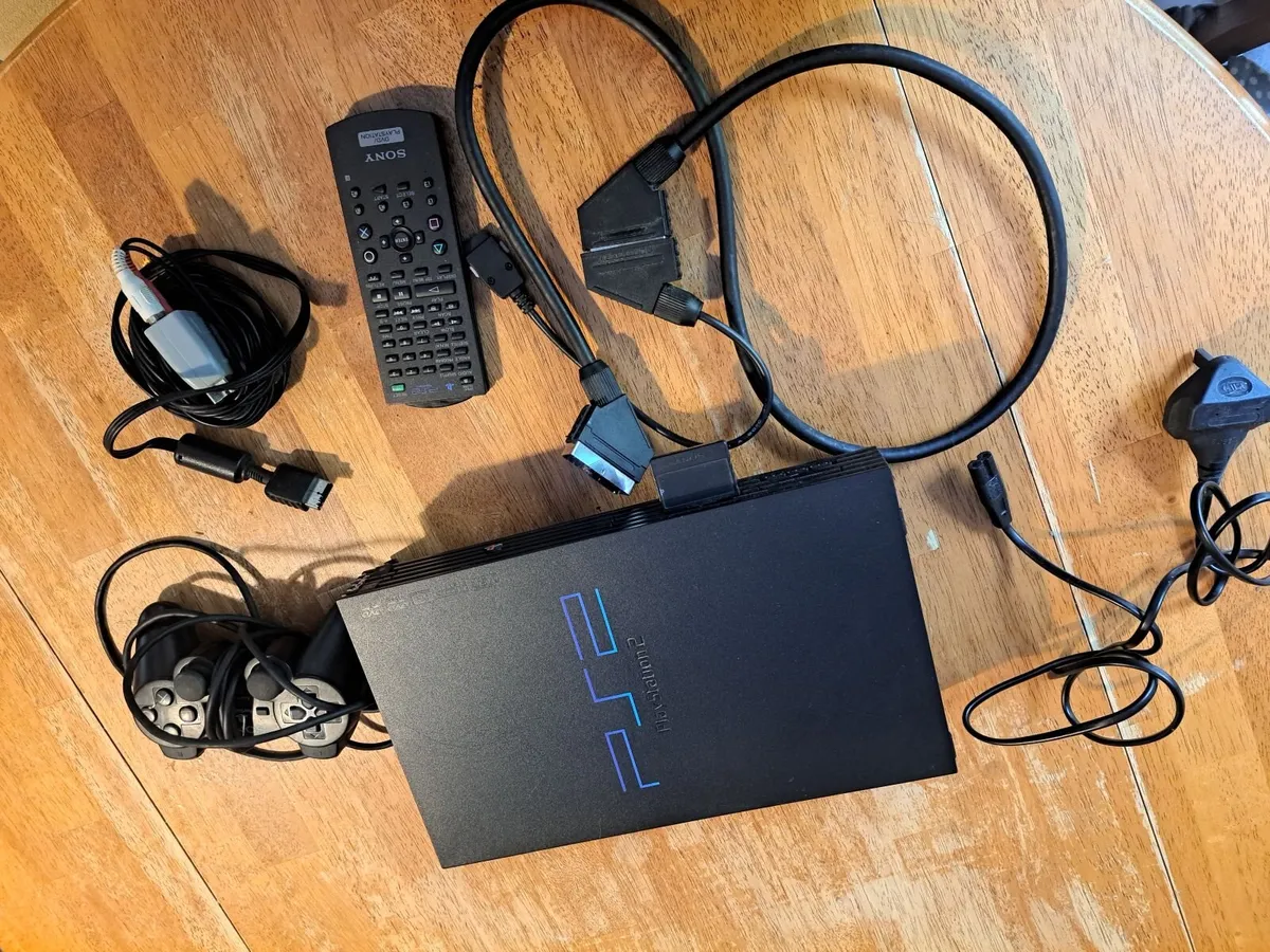 PS2 with controller,remote,cables and 2 games - Image 1
