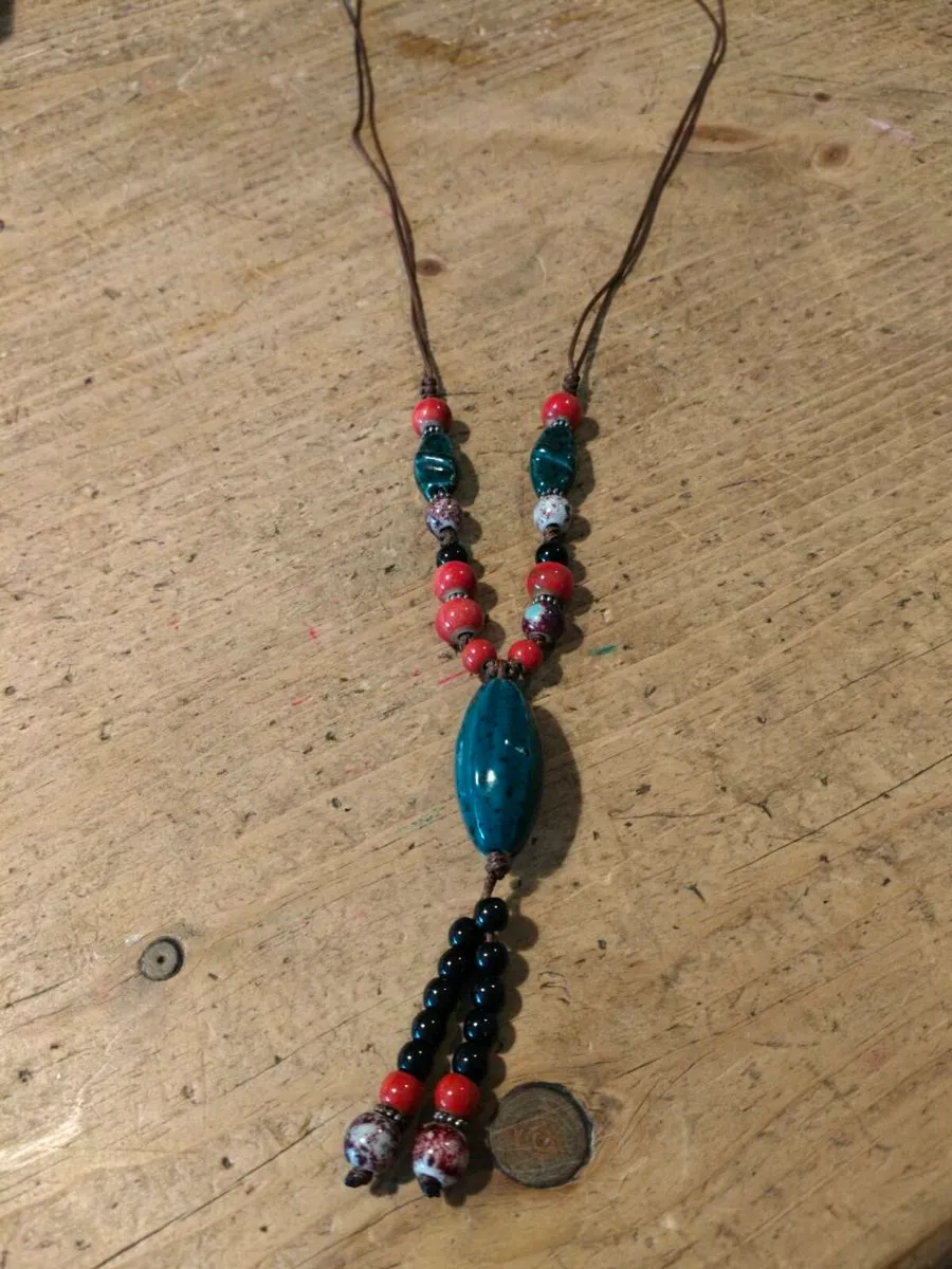 This Bohemian-style necklace features a prominent - Image 1