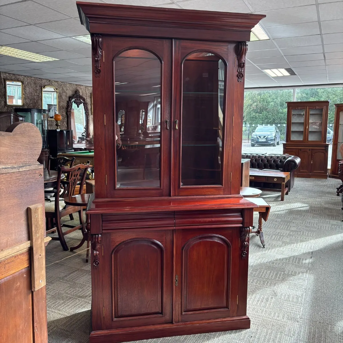 Victorian style mahogany display cabinet with a mo