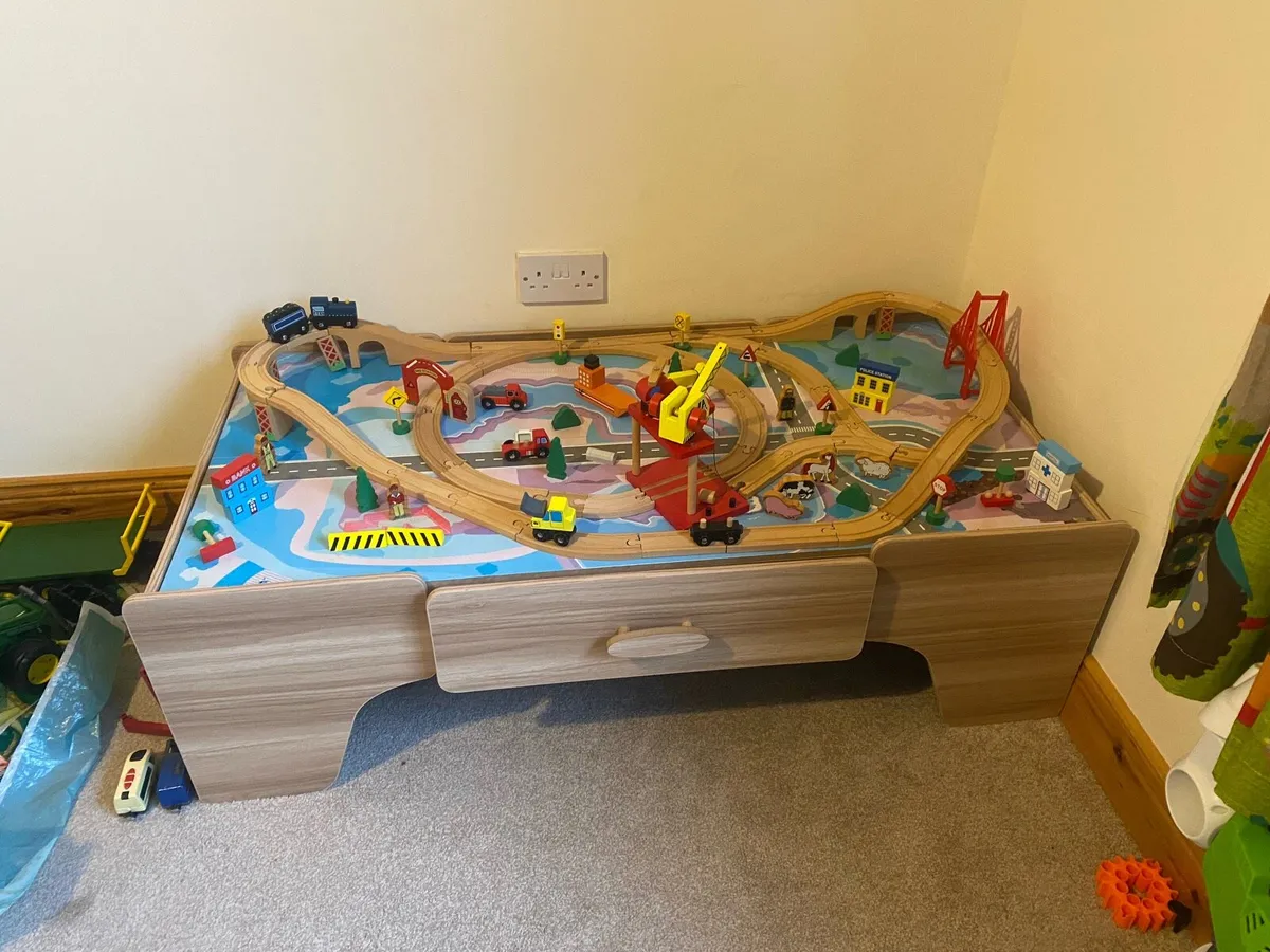 Kids wooden train tracks on table - Image 1