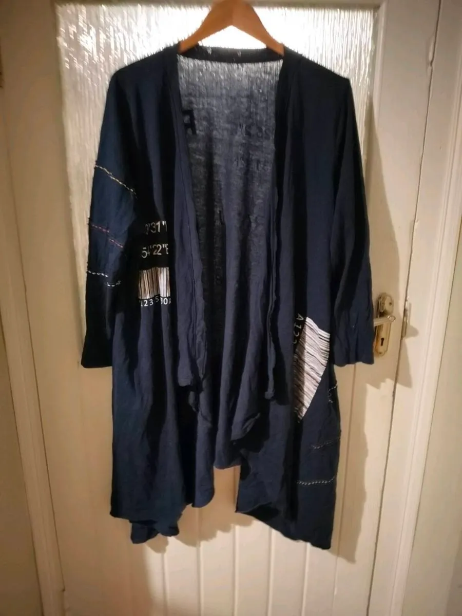 long-sleeved navy garment is an oversized graphic - Image 1