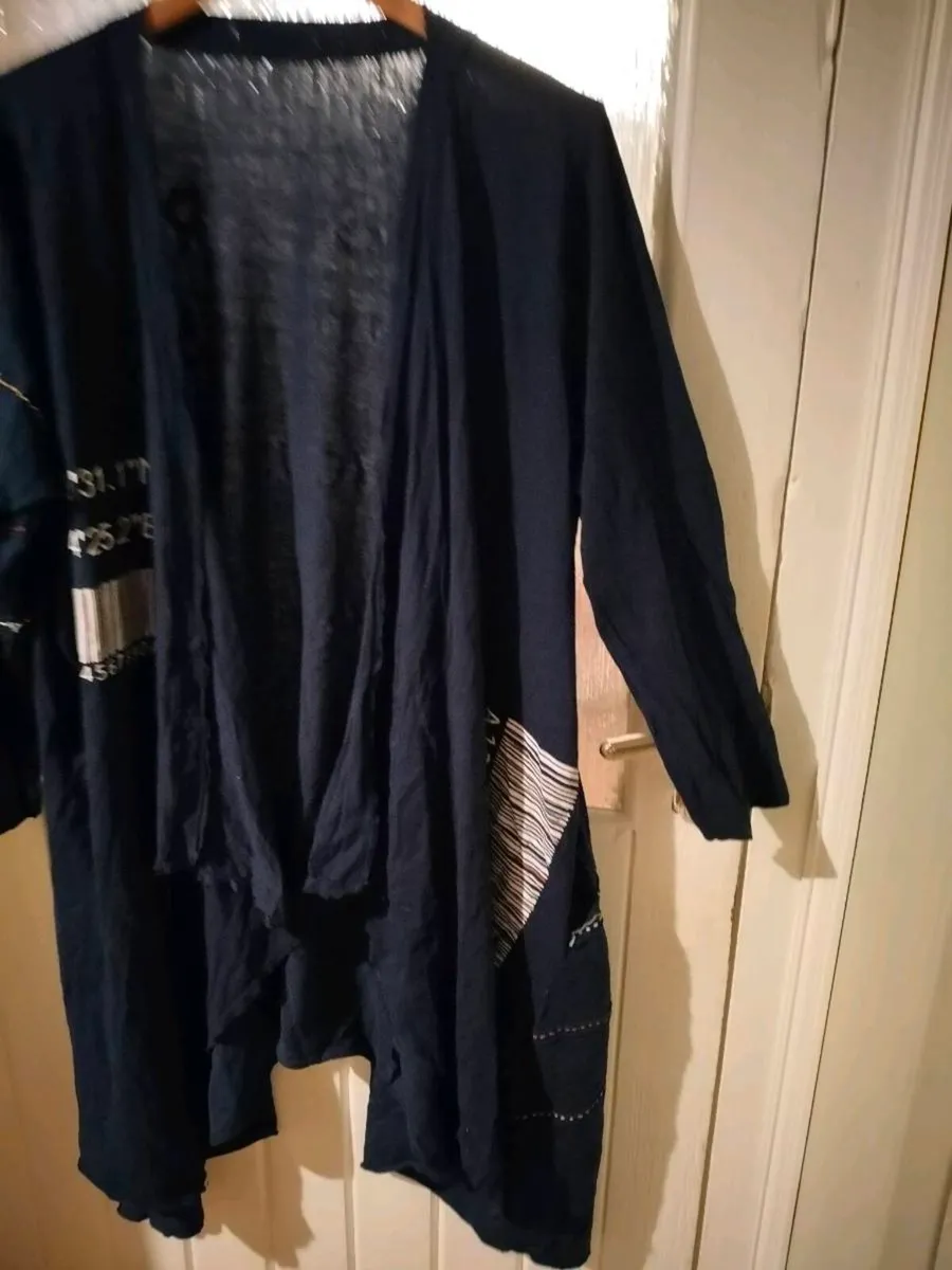 long-sleeved navy garment is an oversized graphic - Image 3
