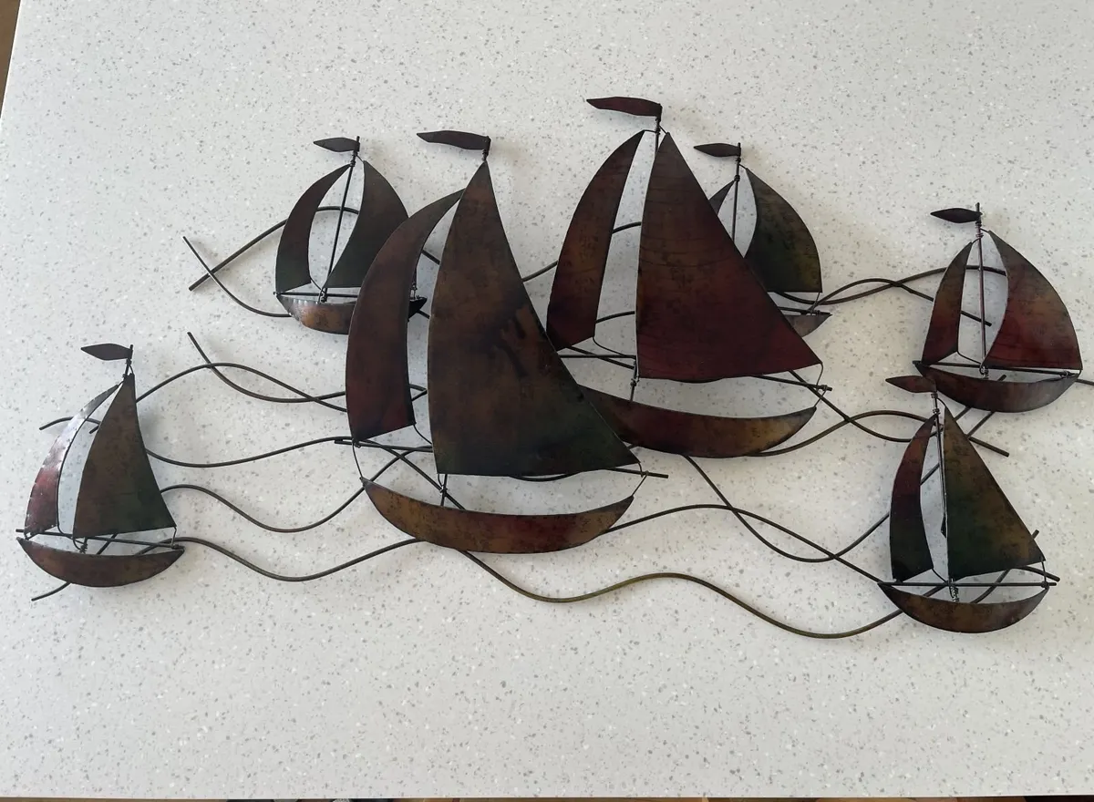 Large metal wall sculpture of sailboats on waves