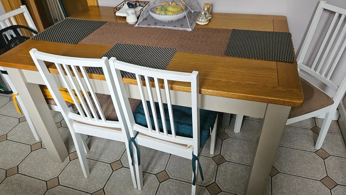 Wood Dining table and padded chairs - Image 1