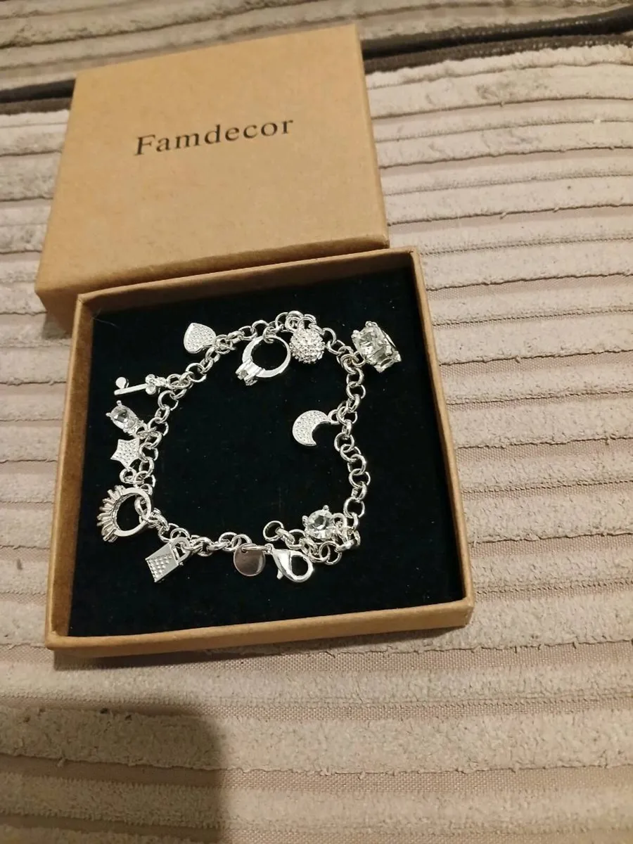 Heavy silver plated charm bracelet 11 charms on it