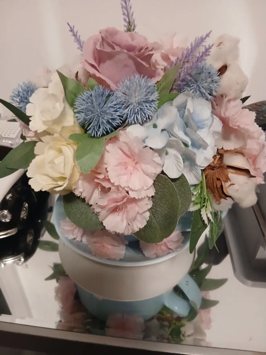 A lovely.flowers  in a cup and saucer.