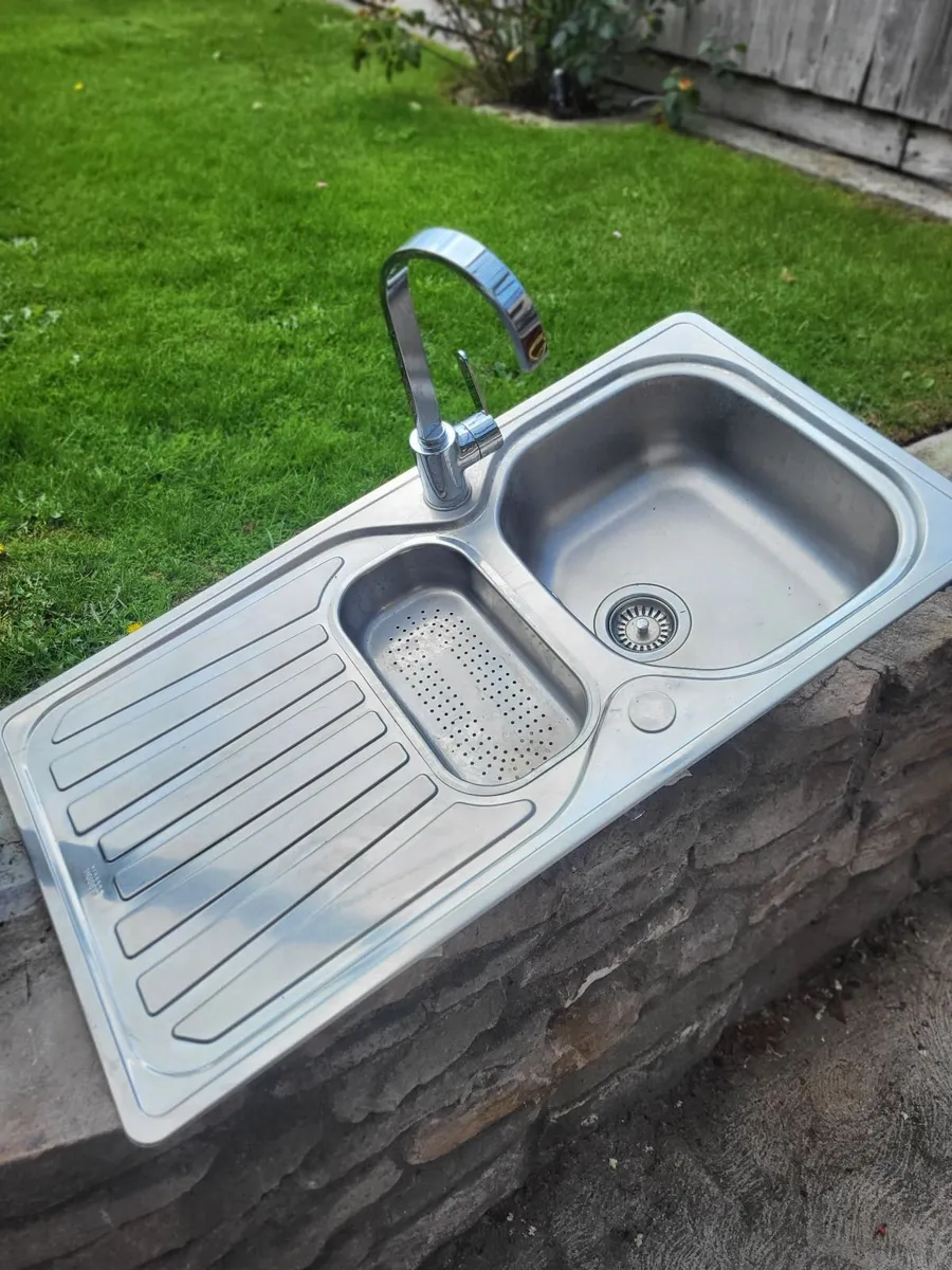 A double kitchen sink with tap