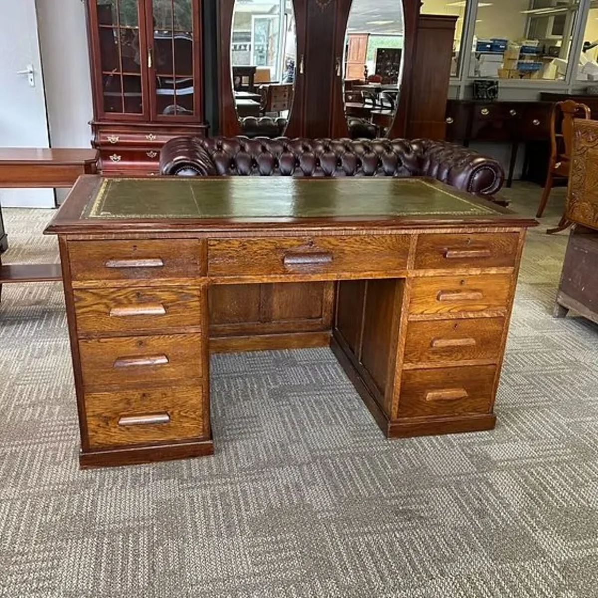 Substantial traditional oak desk with a green tool