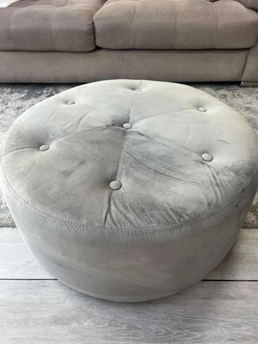 Grey suede footstool.