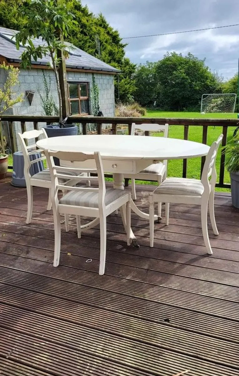 Antique Oval drop leaf table with claw legs and four chairs - Image 1