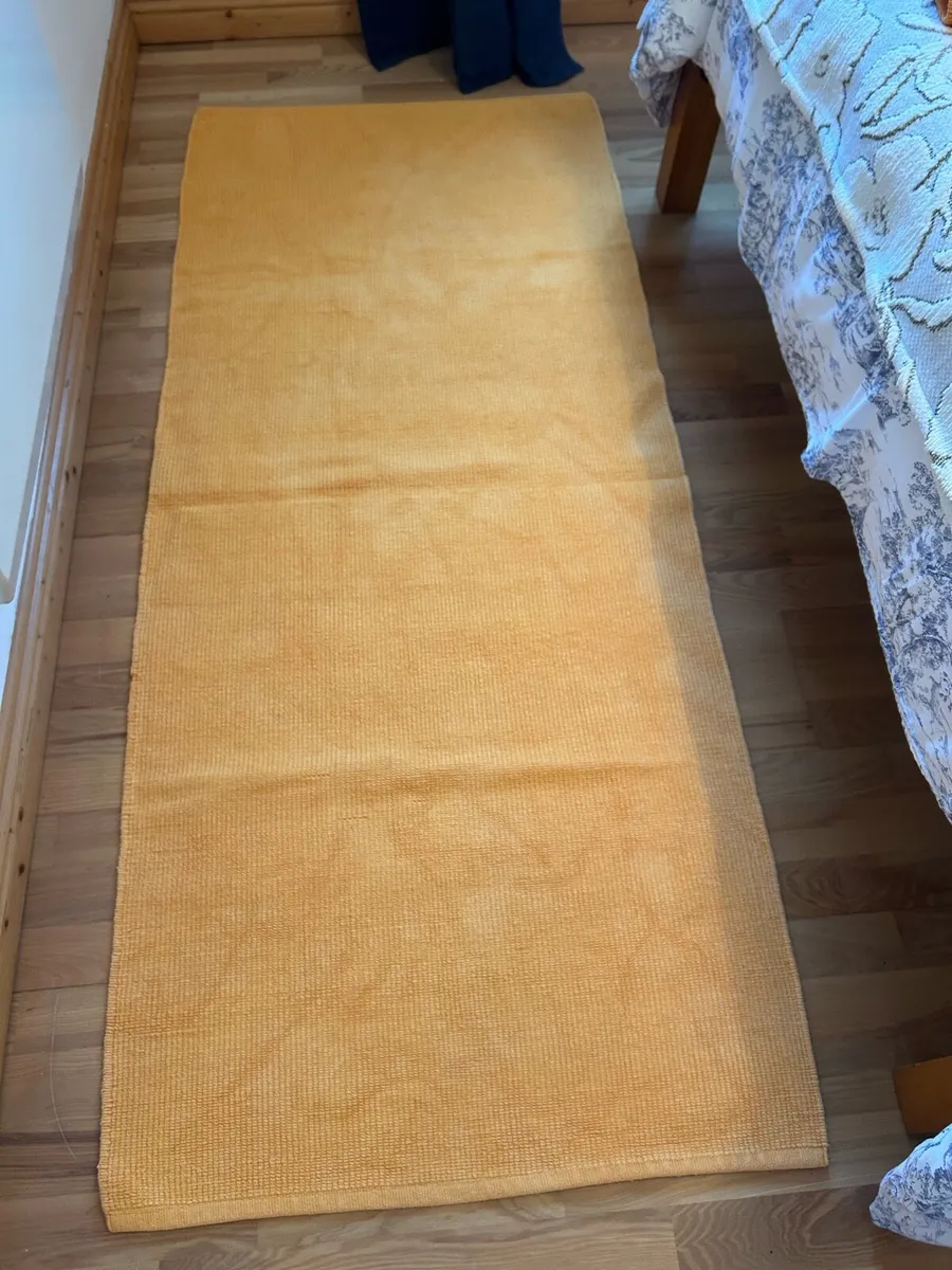 Orange ikea rugs x 4 with non-slip under lays. - Image 1
