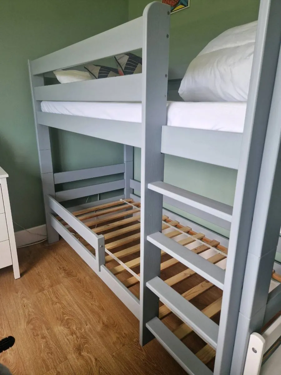 Grey wood bunk beds with mattresses - Image 1