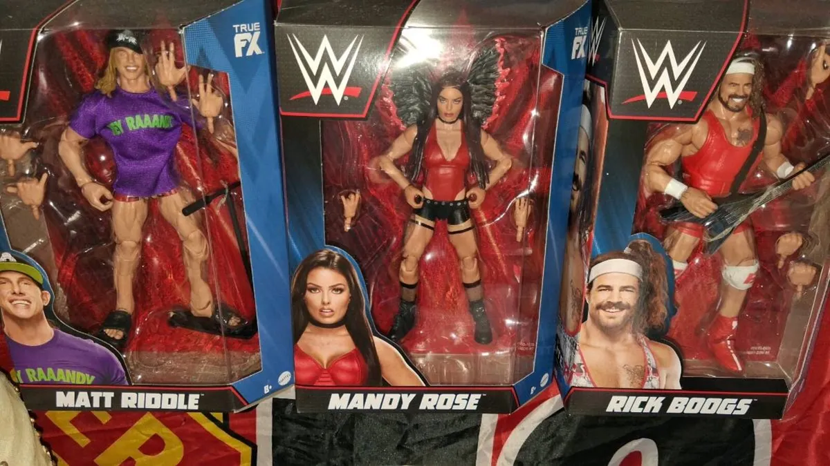 4 WWE Figures in boxesS - Image 1