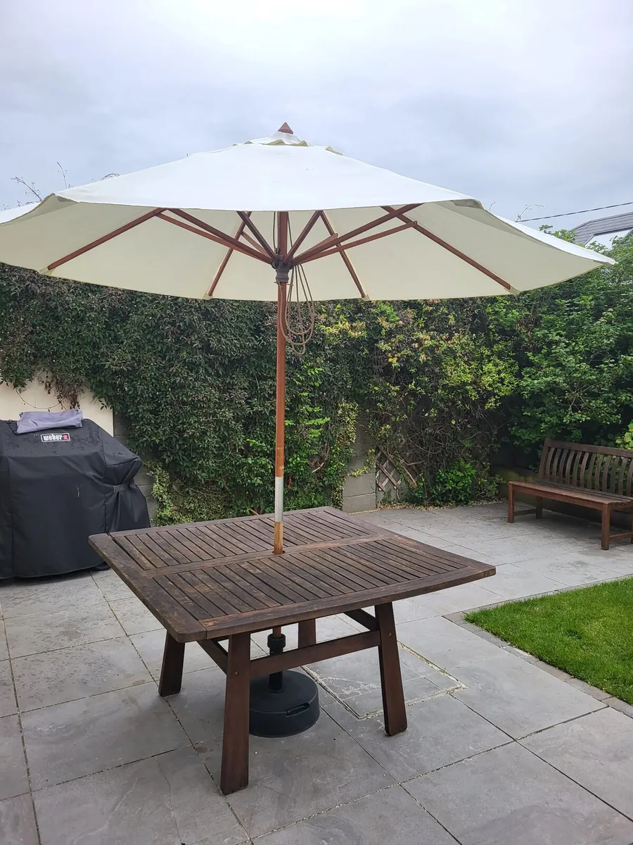 Square wooden garden table and parasol