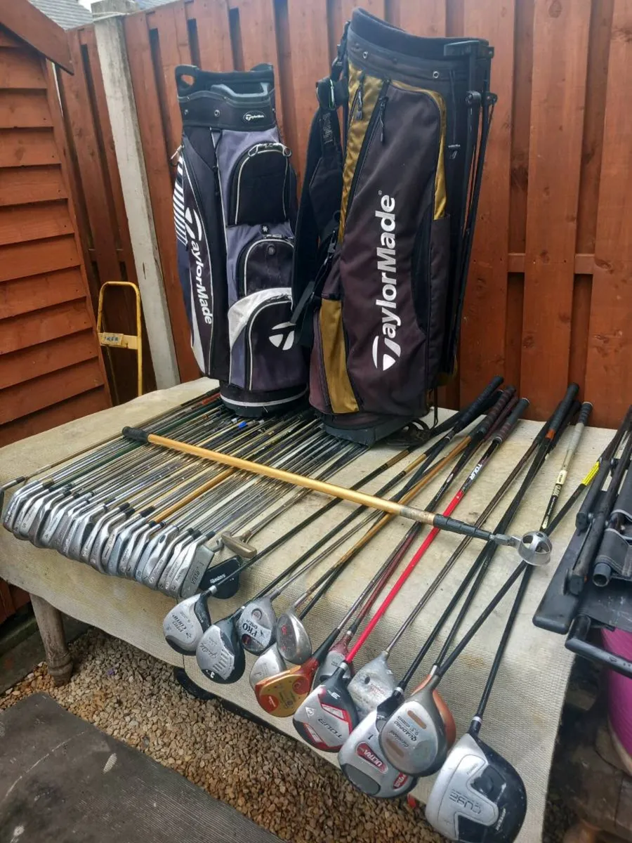 A selection of golf clubs and bags. - Image 1