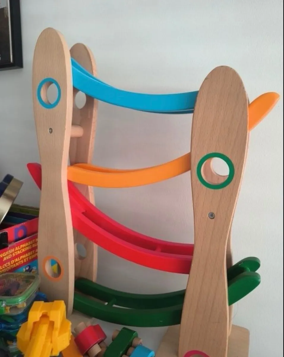 Wooden Car Roll toy with a natural wood frame and