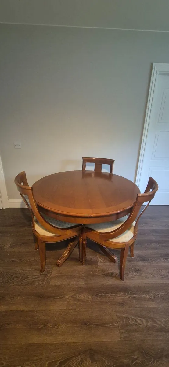 Marcoan Round to Oval Dining Table and Chairs - Image 1