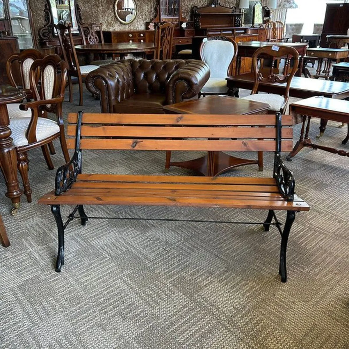 A powder coated cast metal ended garden bench. - Image 1