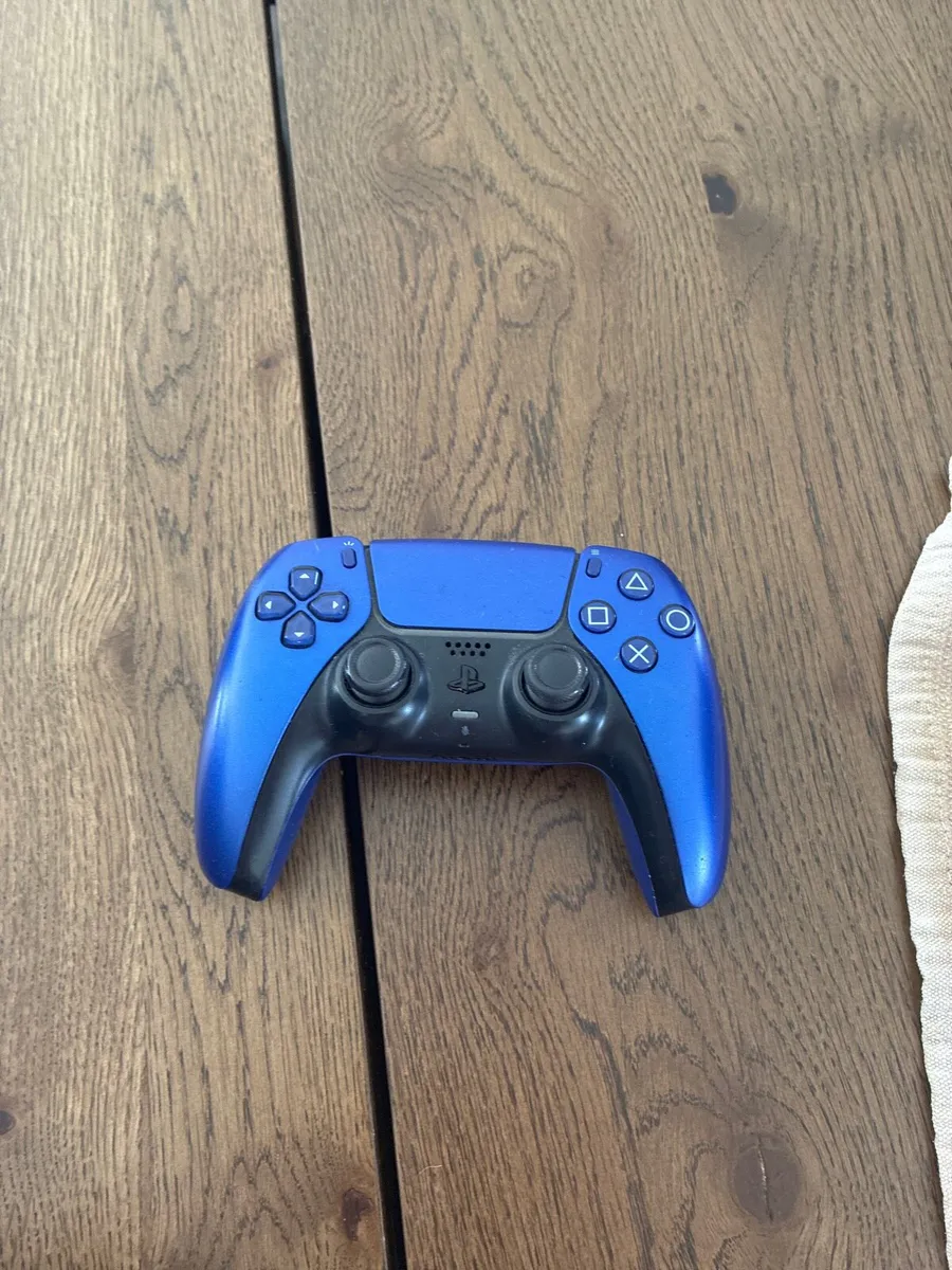 PS5 and a blue ps5 controller - Image 1