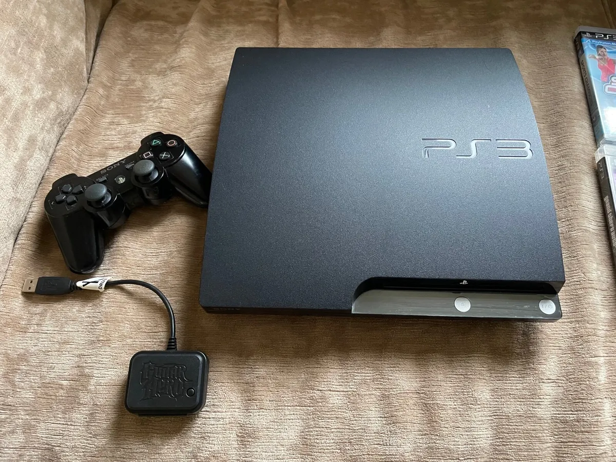 Playstation 3 with games and Guitar Hero drum kit - Image 1
