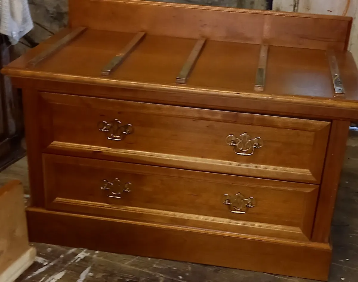 Chest of drawers with suitcase set down on top - Image 1