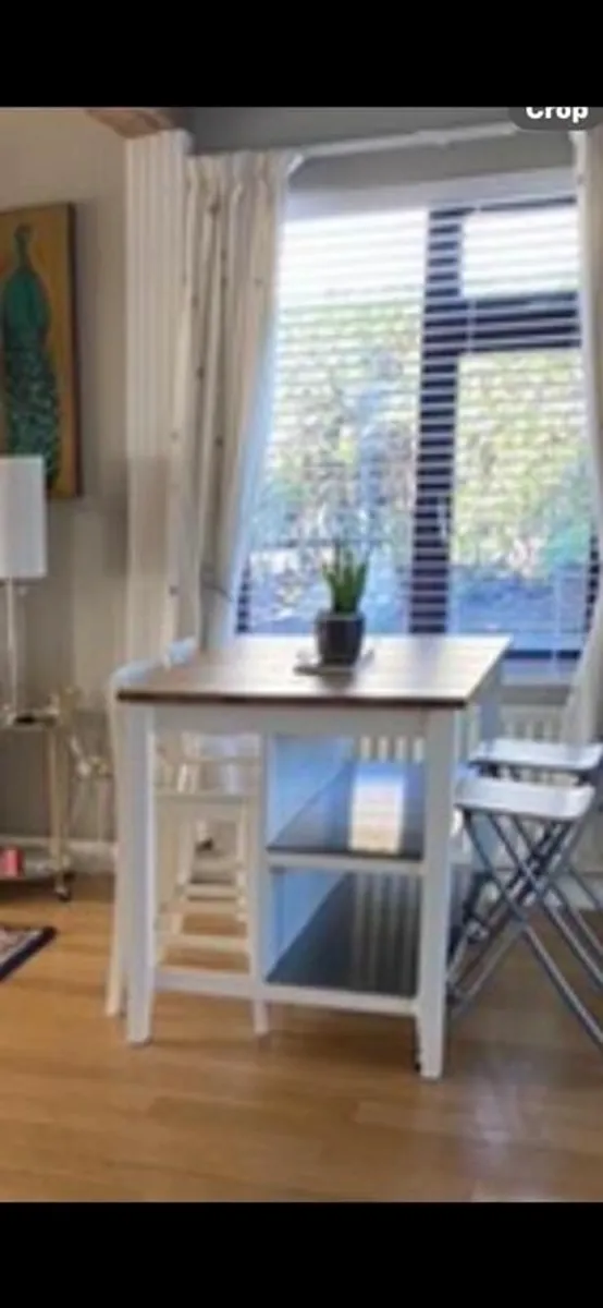 IKEA Free-standing kitchen island with foldable chairs. - Image 1