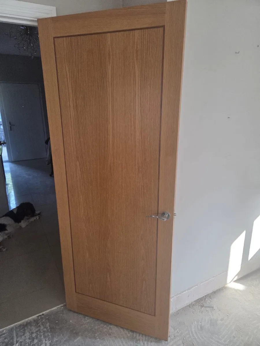 Solid oak interior door with decorative inlay.