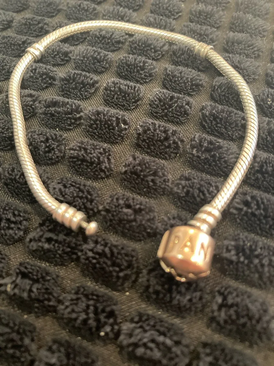 Silver Pandora bracelet with gold tone lock - Image 1