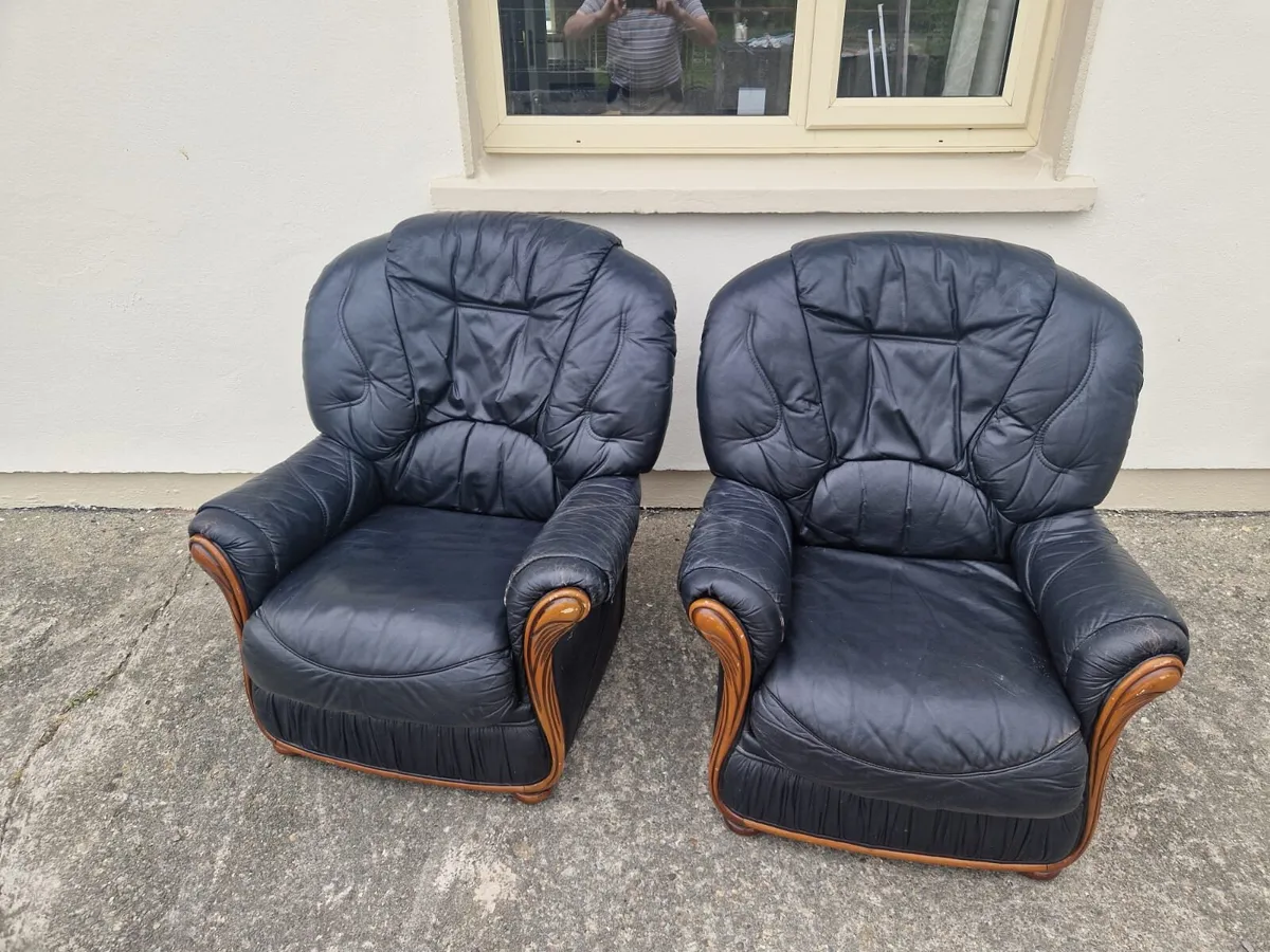 Two black leather armchairs
