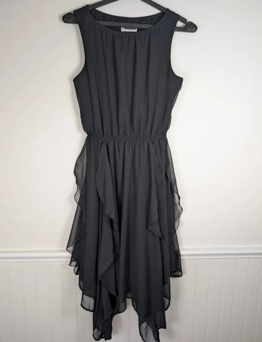 Girls H&M black sleeveless dress featuring a round