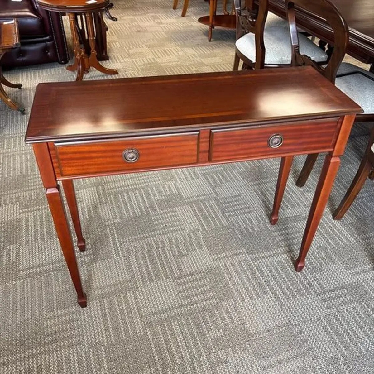 Mahogany console table raised on fluted turn legs