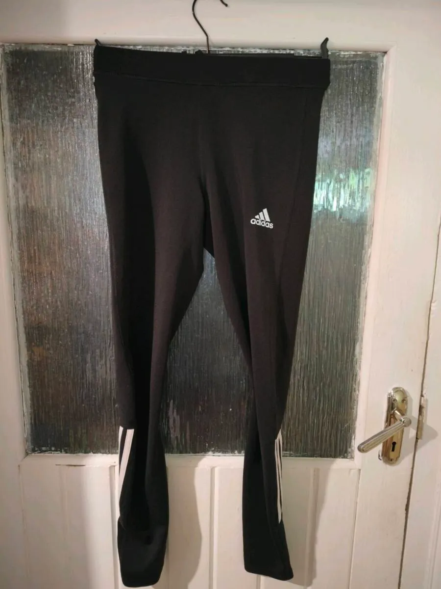 black Adidas Techfit leggings featuring white bran - Image 1