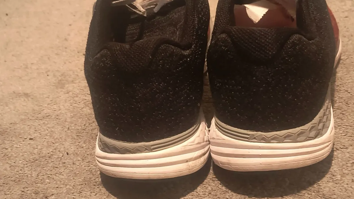 athletic sneaker features a red and black 9 - Image 2