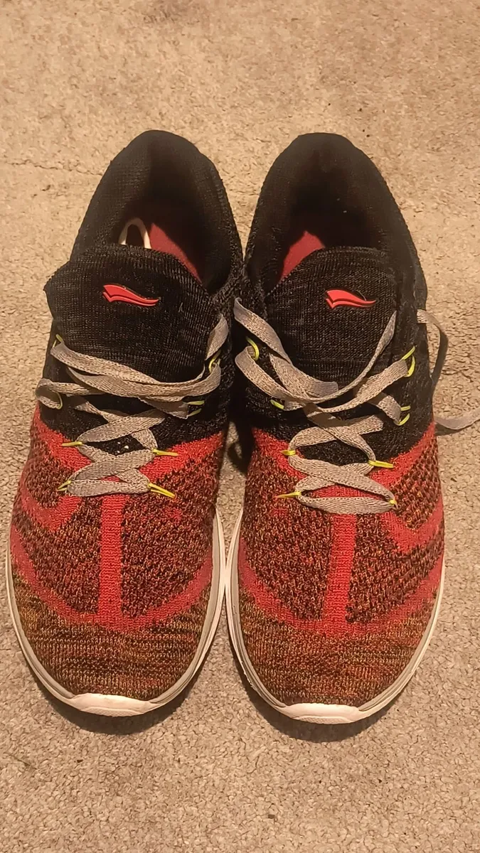 athletic sneaker features a red and black 9 - Image 4