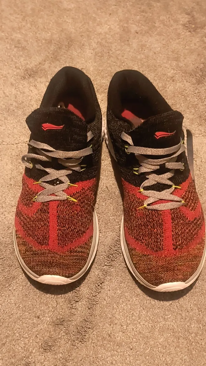 athletic sneaker features a red and black 9 - Image 1