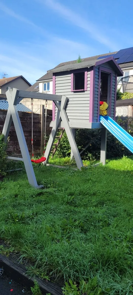 Wooden playhouse with swing and slide - Image 1