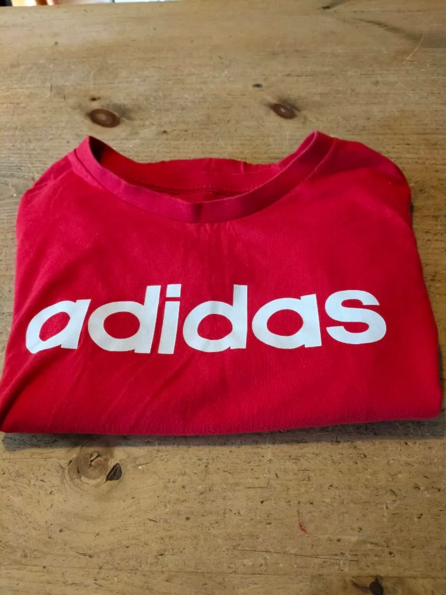 red Adidas t-shirt features a prominent white logo - Image 3