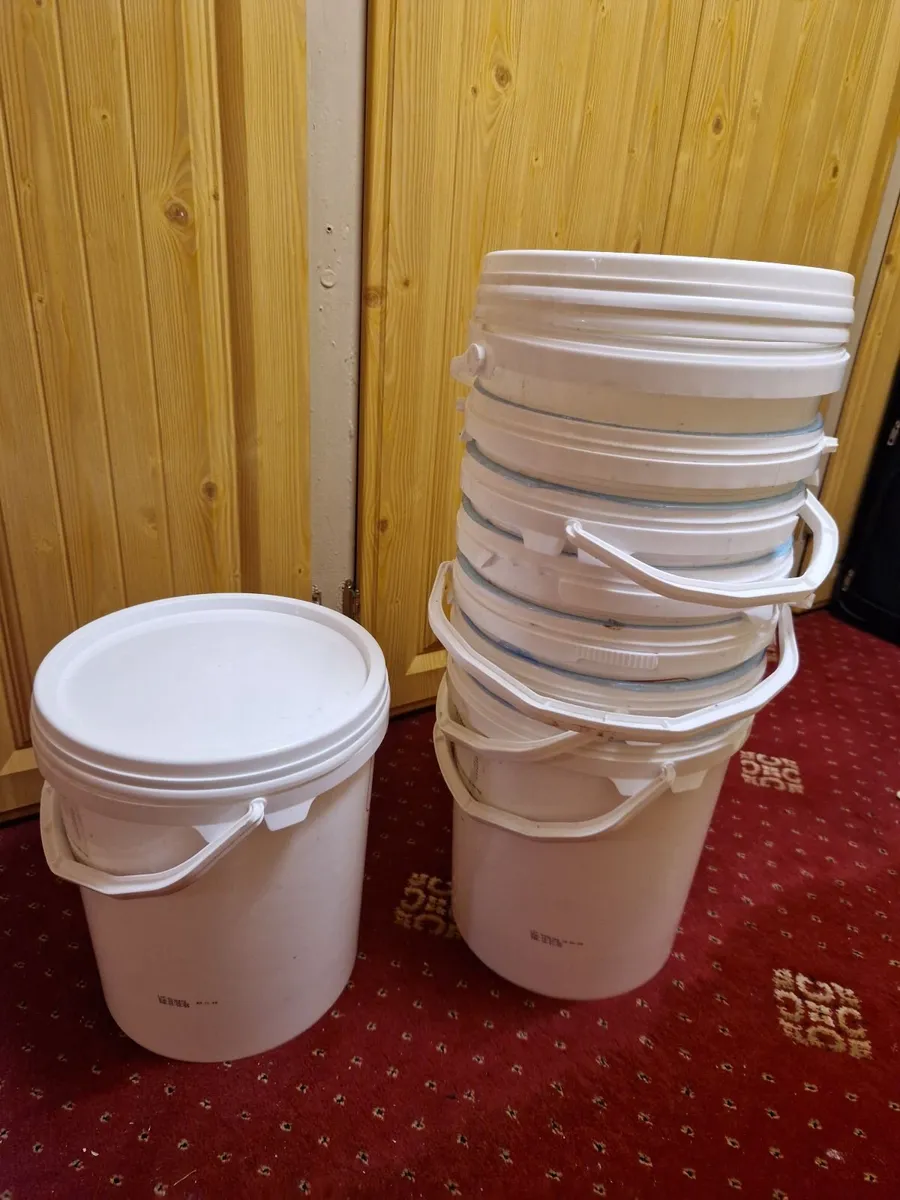 Plastic buckets with lids.