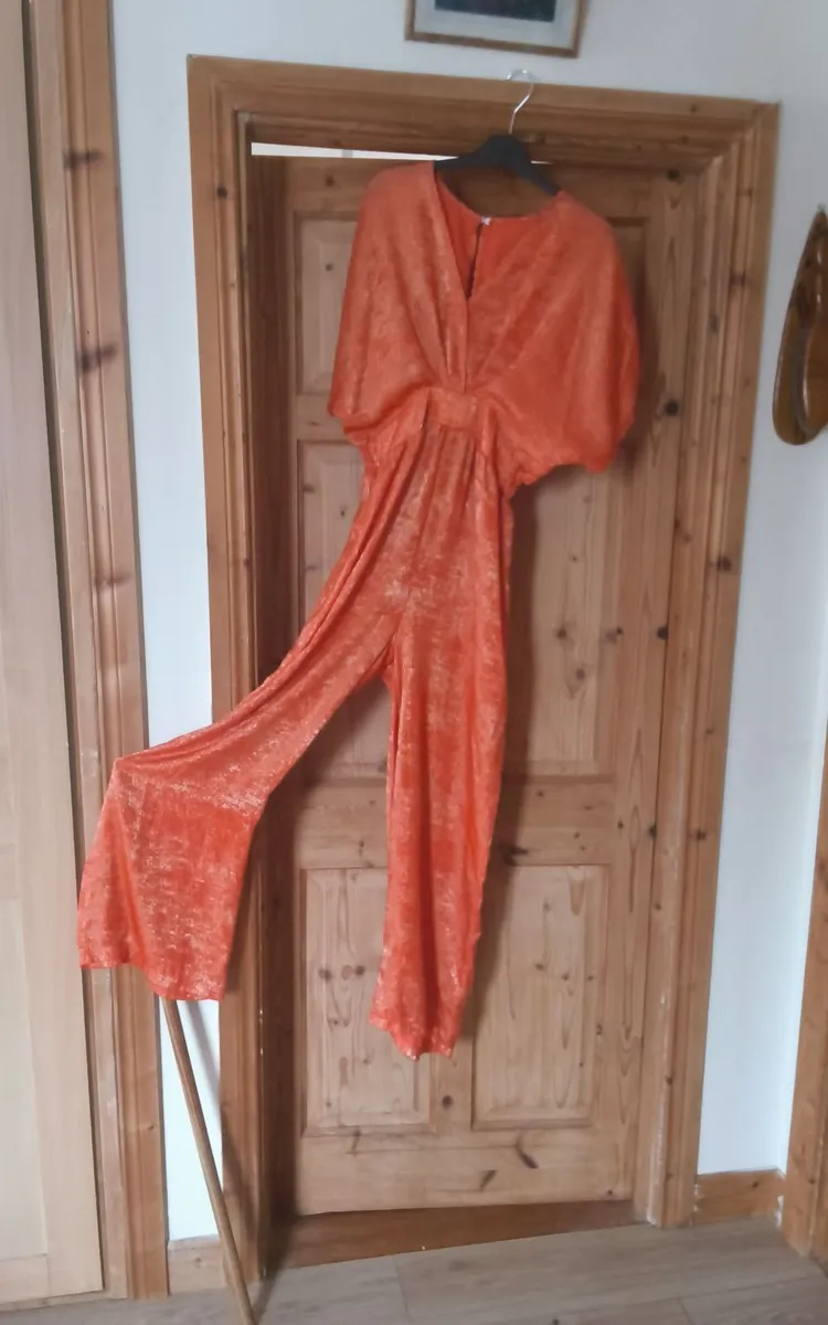 Orange coloured jump suite as new - Image 1