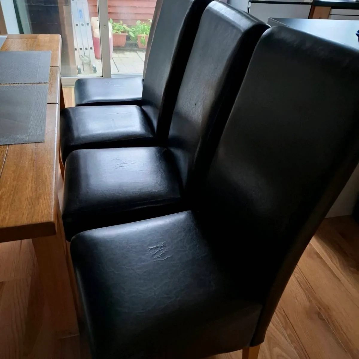 4 Black leather style kitchen chairs. - Image 1