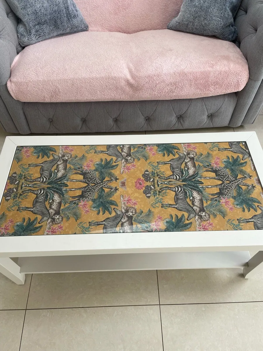 Glass topped coffee table with jungle theme - Image 1