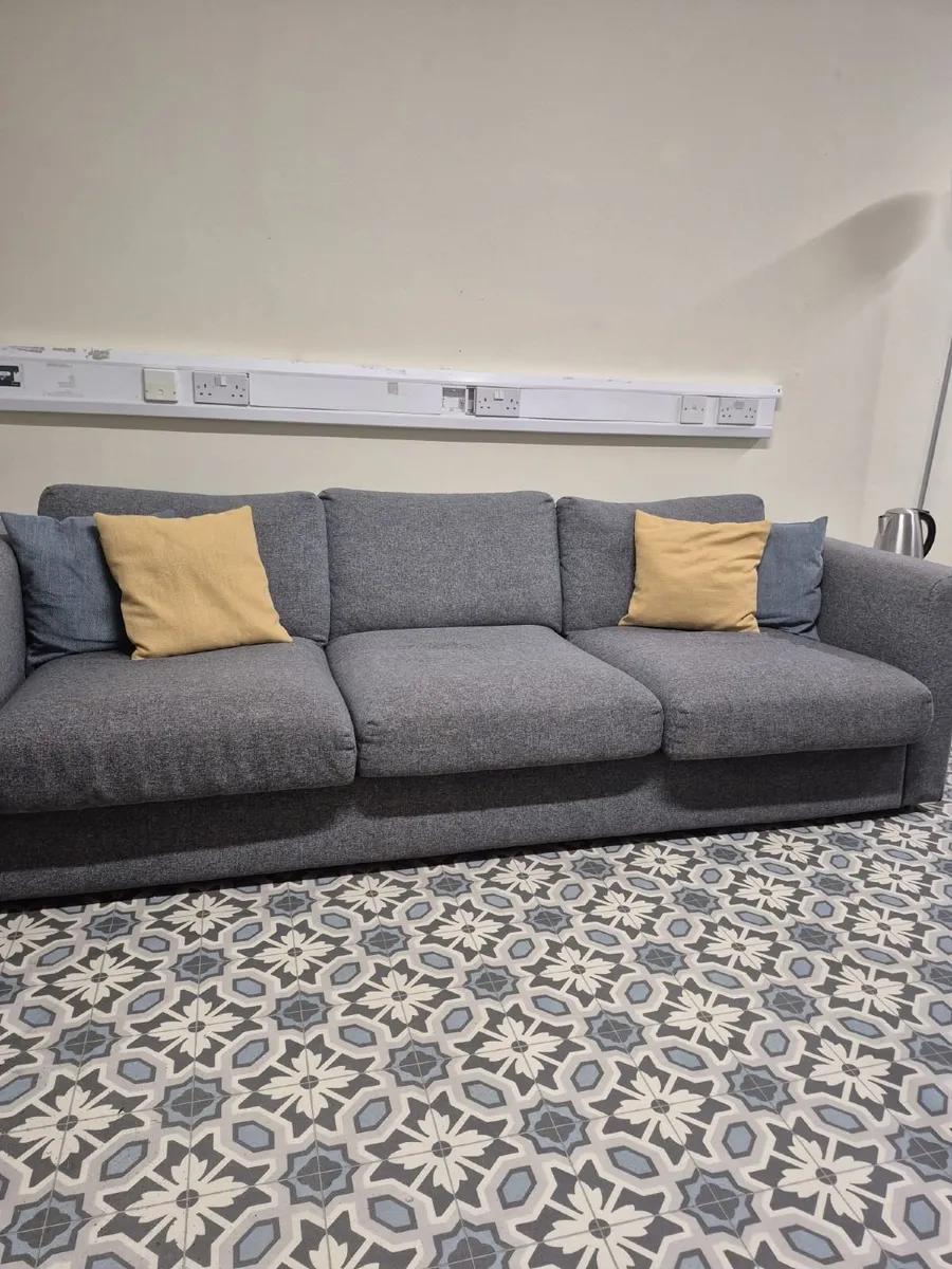 Grey three-seater fabric sofa - Image 1